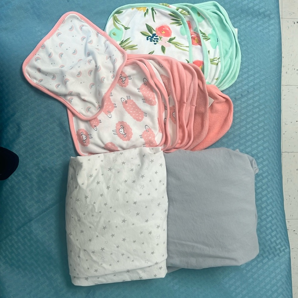 13 baby washcloths and 2 crib sheets